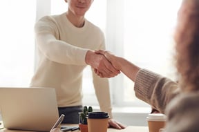 young man giving a young woman a handshake